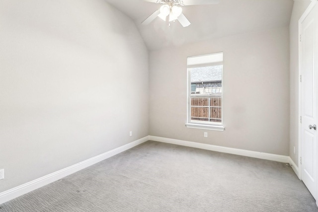 unfurnished room with baseboards, lofted ceiling, ceiling fan, and carpet floors