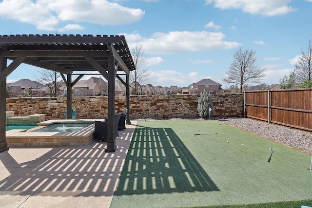 view of patio / terrace with an in ground hot tub, a fenced backyard, and a pergola