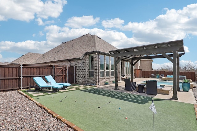 view of patio / terrace with an in ground hot tub, a fenced backyard, and a pergola