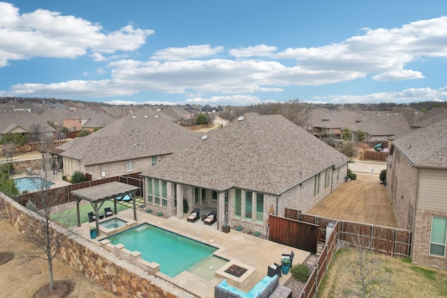 view of swimming pool featuring a gazebo, a fire pit, a fenced backyard, and a patio area