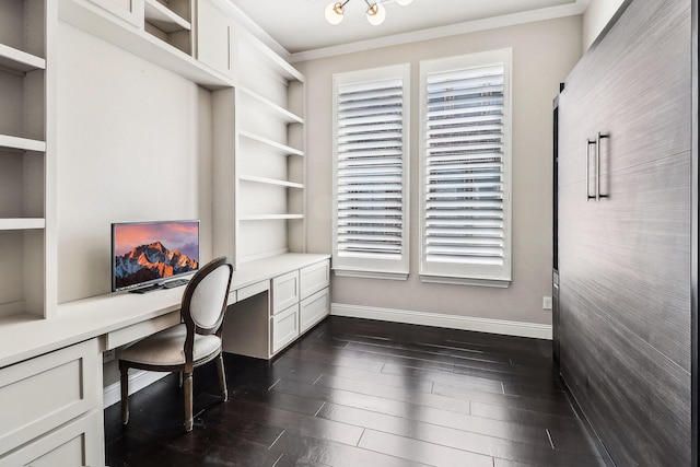 office space featuring built in shelves, baseboards, ornamental molding, built in study area, and dark wood-style flooring