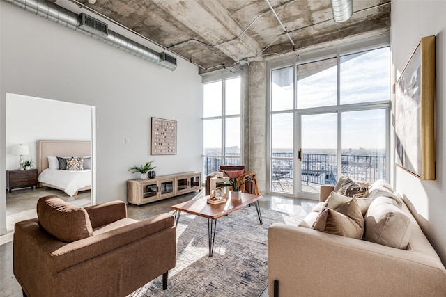 living area with a wall of windows and a high ceiling