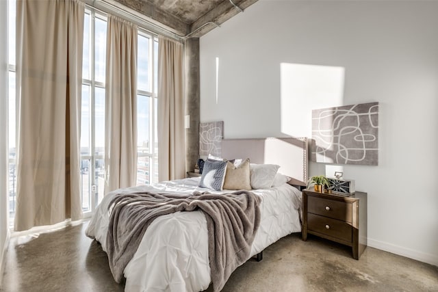 bedroom featuring concrete flooring