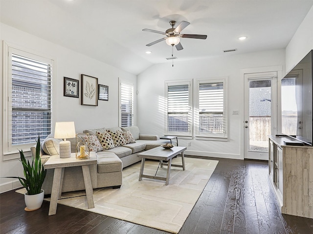 living room featuring a ceiling fan, baseboards, visible vents, lofted ceiling, and dark wood-style flooring