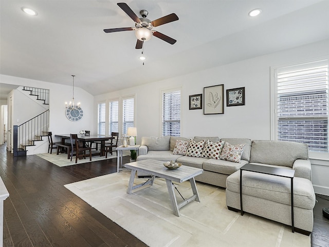 living room featuring stairs, vaulted ceiling, recessed lighting, light wood-style flooring, and ceiling fan with notable chandelier