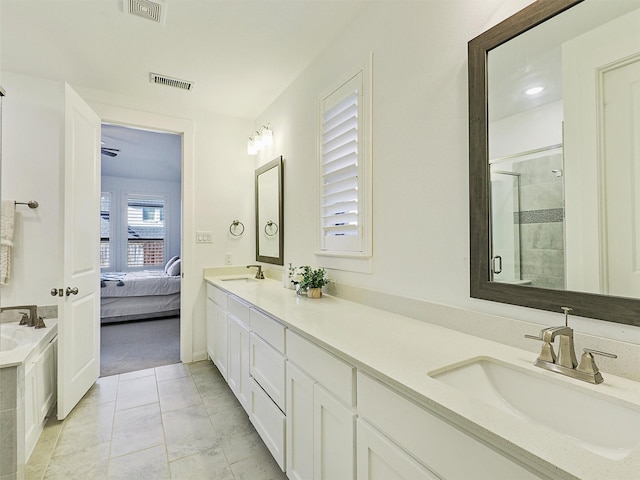 bathroom featuring visible vents, a stall shower, and a sink