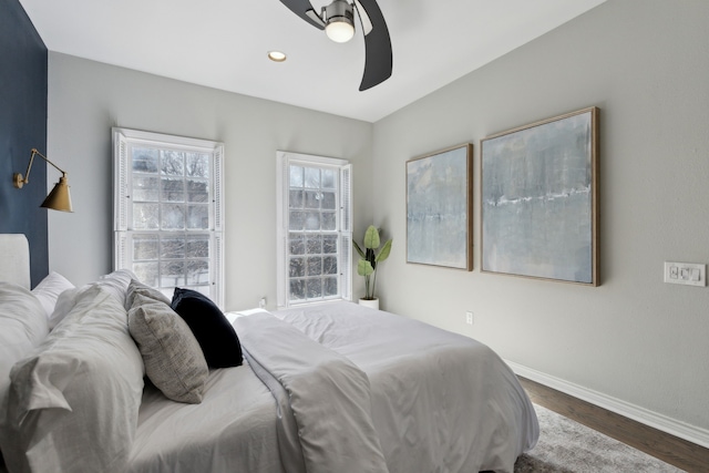 bedroom with a ceiling fan, recessed lighting, wood finished floors, and baseboards