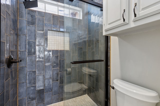 full bathroom featuring toilet and a stall shower