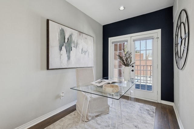 interior space featuring baseboards and wood finished floors