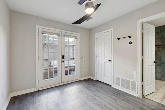 entryway with visible vents, french doors, a ceiling fan, and wood finished floors