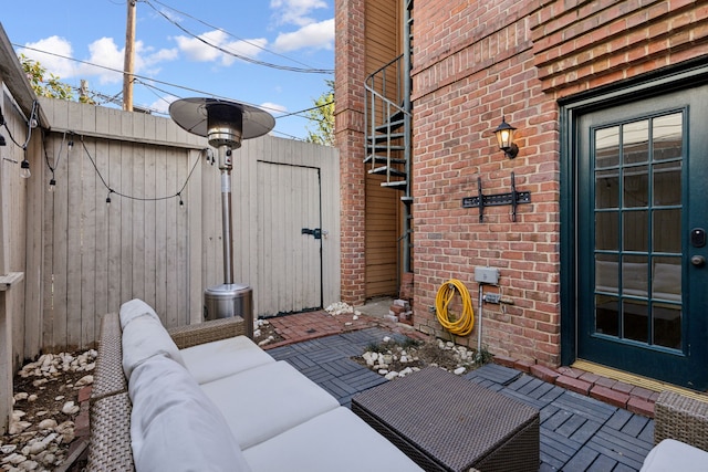 view of patio / terrace with an outdoor living space, fence, and a gate