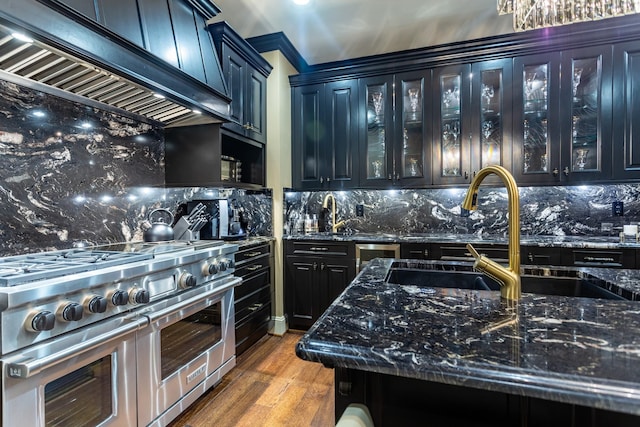 kitchen with dark stone countertops, double oven range, decorative backsplash, dark wood-type flooring, and custom range hood