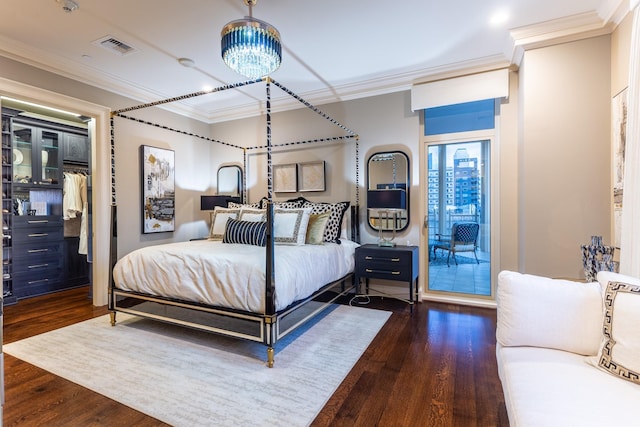 bedroom with visible vents, ornamental molding, and wood finished floors