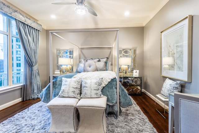 bedroom with ceiling fan, baseboards, wood finished floors, and crown molding