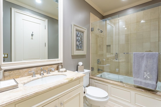 bathroom featuring vanity, toilet, bath / shower combo with glass door, and ornamental molding