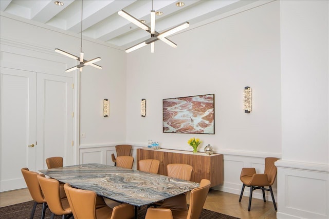 dining area with wainscoting and a decorative wall