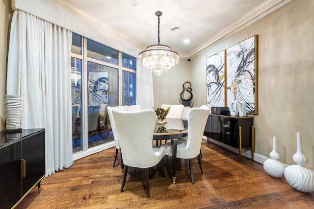 dining room featuring wood finished floors, baseboards, visible vents, an inviting chandelier, and ornamental molding