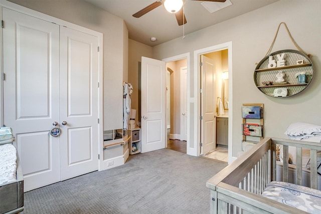 bedroom with a closet, a ceiling fan, a nursery area, and carpet floors