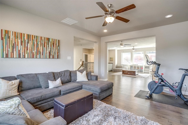 living area with wood finished floors, baseboards, visible vents, recessed lighting, and ceiling fan