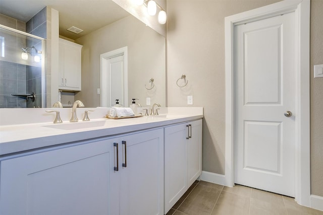 bathroom featuring a sink, visible vents, a stall shower, and double vanity