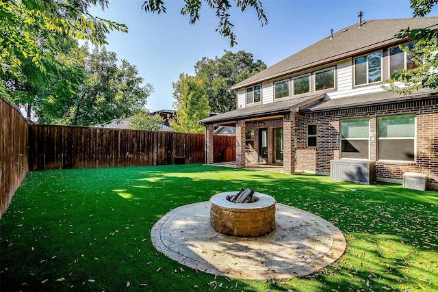 view of yard featuring an outdoor fire pit and a fenced backyard