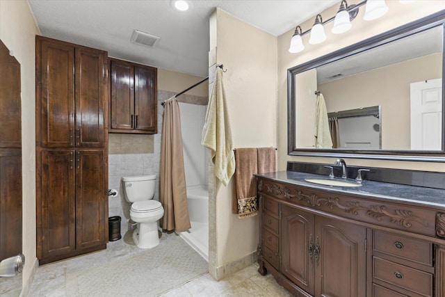 bathroom with visible vents, a shower with curtain, toilet, tile patterned flooring, and vanity