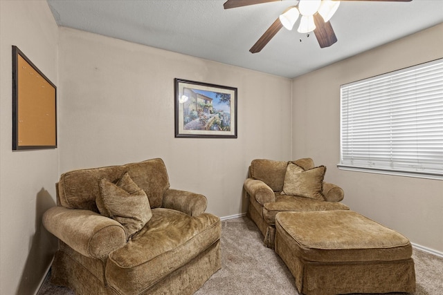 sitting room with carpet flooring, baseboards, and ceiling fan