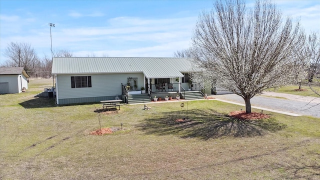 view of front of home featuring a front lawn and metal roof