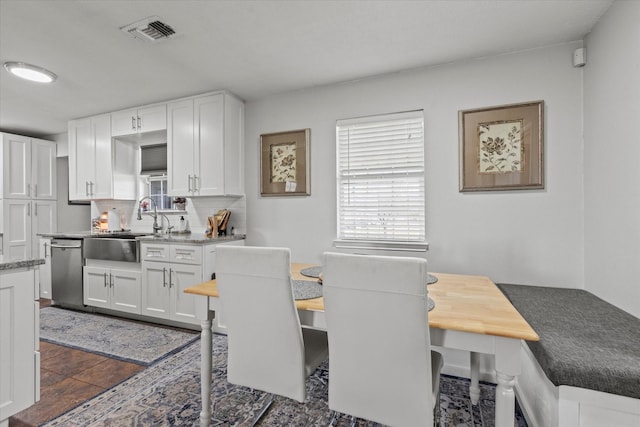 dining room featuring plenty of natural light and visible vents