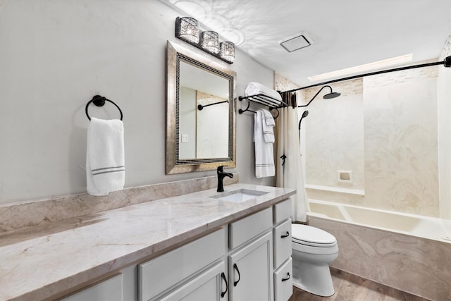 bathroom with vanity, toilet, wood finished floors, and shower / tub combo with curtain