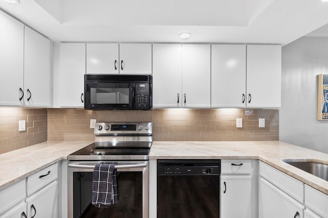 kitchen featuring white cabinetry, black appliances, and light stone countertops