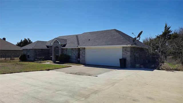 view of front facade featuring brick siding, a garage, and driveway