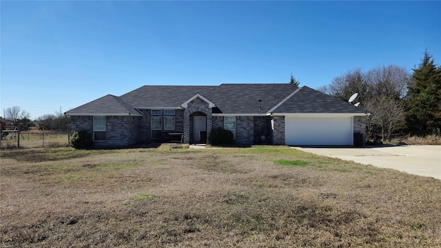 ranch-style home featuring concrete driveway, an attached garage, brick siding, and a front lawn