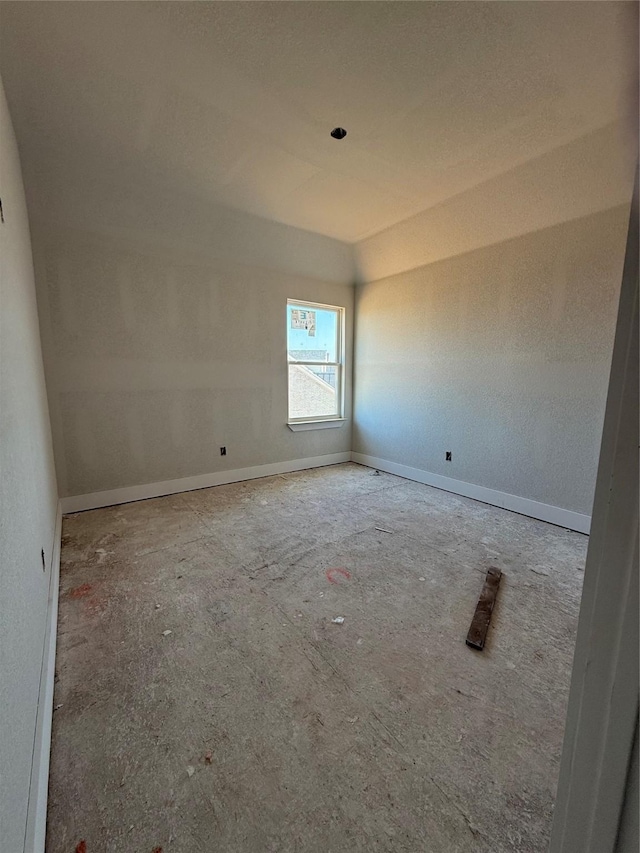 unfurnished room with baseboards