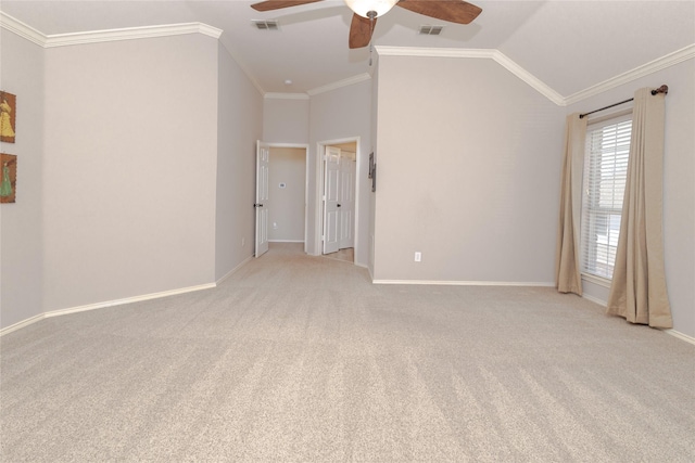 spare room with visible vents, lofted ceiling, a ceiling fan, and ornamental molding