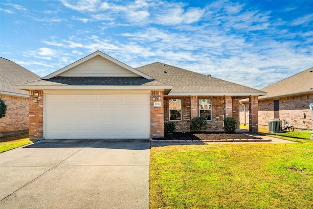 view of front facade with a front yard, cooling unit, driveway, a shingled roof, and a garage