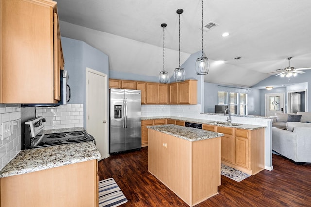 kitchen with visible vents, a sink, open floor plan, a peninsula, and appliances with stainless steel finishes