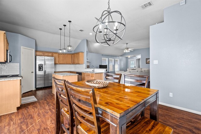 dining room featuring dark wood finished floors, visible vents, and ceiling fan with notable chandelier