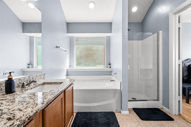 bathroom with a shower stall, recessed lighting, a bath, tile patterned floors, and vanity