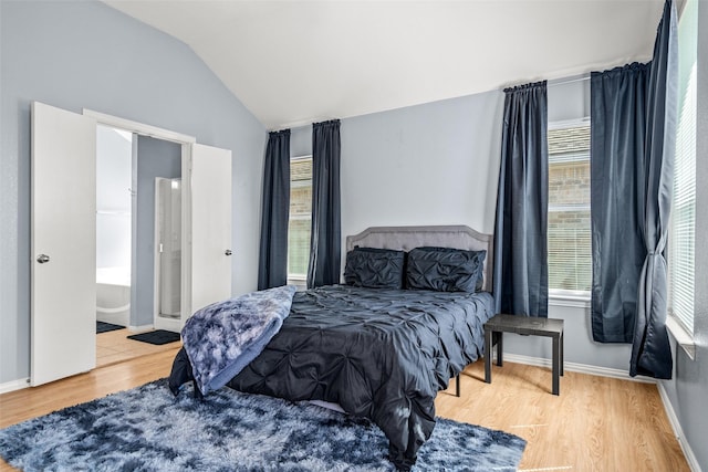 bedroom featuring vaulted ceiling, wood finished floors, and baseboards