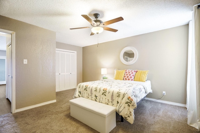 carpeted bedroom featuring a textured ceiling, a ceiling fan, baseboards, and a textured wall