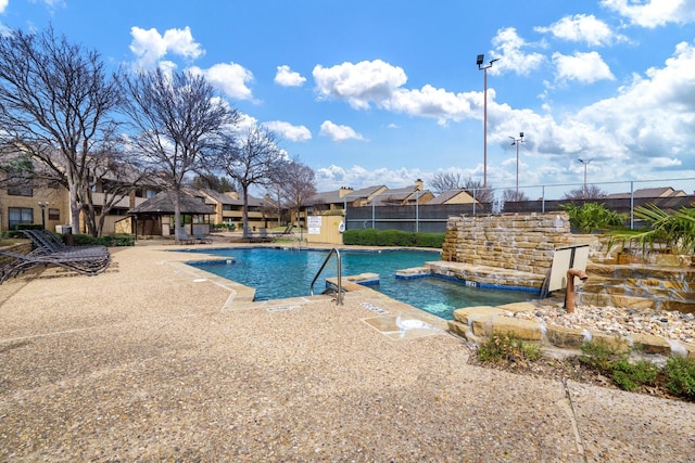 pool with a gazebo, a patio area, a residential view, and fence