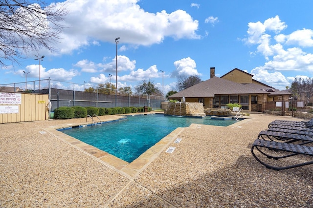 pool featuring a patio area and fence