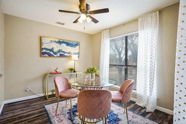 dining space with visible vents, a textured ceiling, and wood finished floors