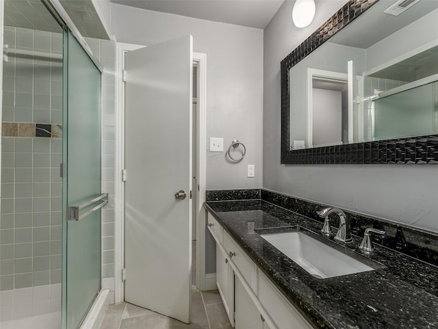 bathroom featuring vanity, tile patterned floors, visible vents, and a stall shower