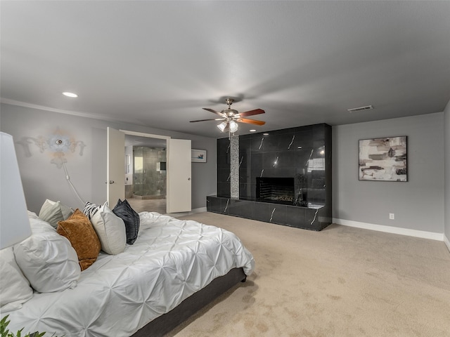 bedroom with visible vents, baseboards, a premium fireplace, carpet flooring, and a ceiling fan