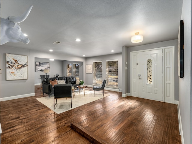 foyer entrance with visible vents, recessed lighting, baseboards, and hardwood / wood-style flooring