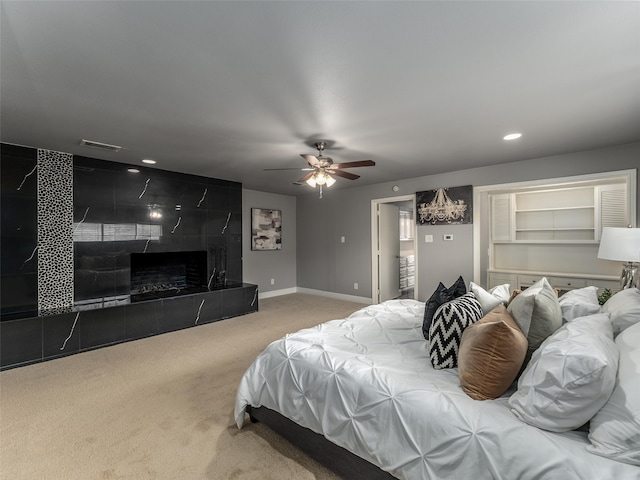 carpeted bedroom featuring a ceiling fan, visible vents, baseboards, recessed lighting, and a fireplace