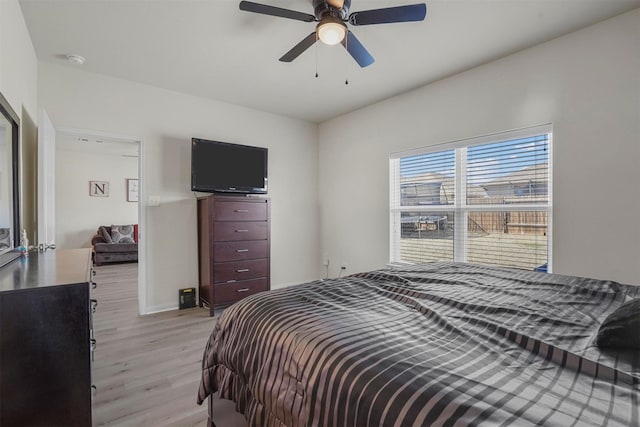 bedroom featuring light wood-style flooring and ceiling fan