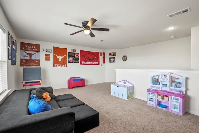 rec room featuring carpet, visible vents, and ceiling fan